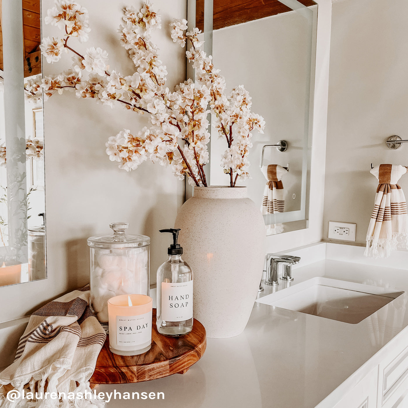 https://www.sweetwaterdecor.com/cdn/shop/products/C037WW-SPA-DAY-WHITE-WOOD-CANDLE-HT017-NEUTRAL-STRIPES-HAND-TOWEL-HAND-SOAP-CLEAR-GLASS-DISPENSER-_laurenashleyhansen_4e059671-ff63-451e-8a73-5c962ba134ef_1400x.jpg?v=1655291737