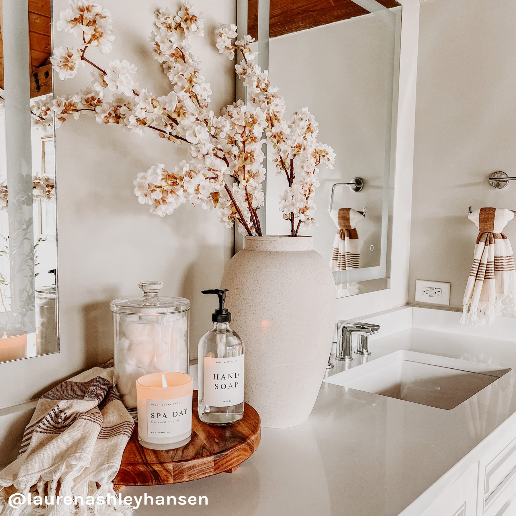 https://www.sweetwaterdecor.com/cdn/shop/products/C037WW-SPA-DAY-WHITE-WOOD-CANDLE-HT017-NEUTRAL-STRIPES-HAND-TOWEL-HAND-SOAP-CLEAR-GLASS-DISPENSER-_laurenashleyhansen_4e059671-ff63-451e-8a73-5c962ba134ef_1800x1800.jpg?v=1655291737