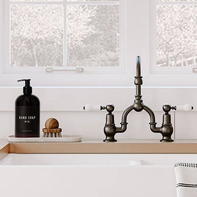 Amber plastic hand soap dispenser with black label